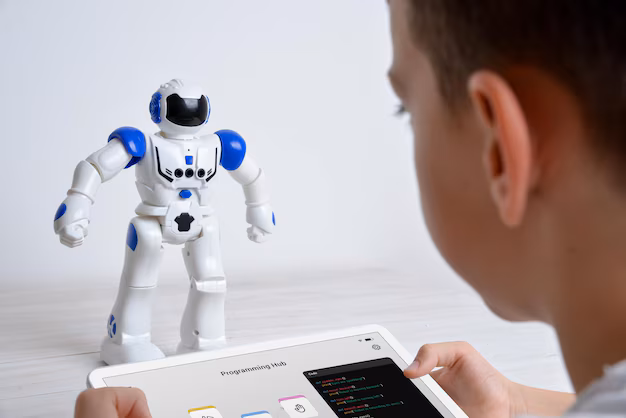 child programming educational robot with tablet - Boy controls robot using tablet on desk illustrating education ...