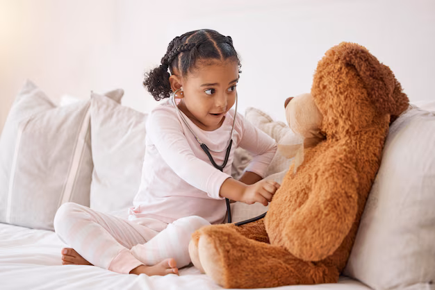 child playing with smart teddy bear - Learning child with stethoscope check teddy bear with love ...
